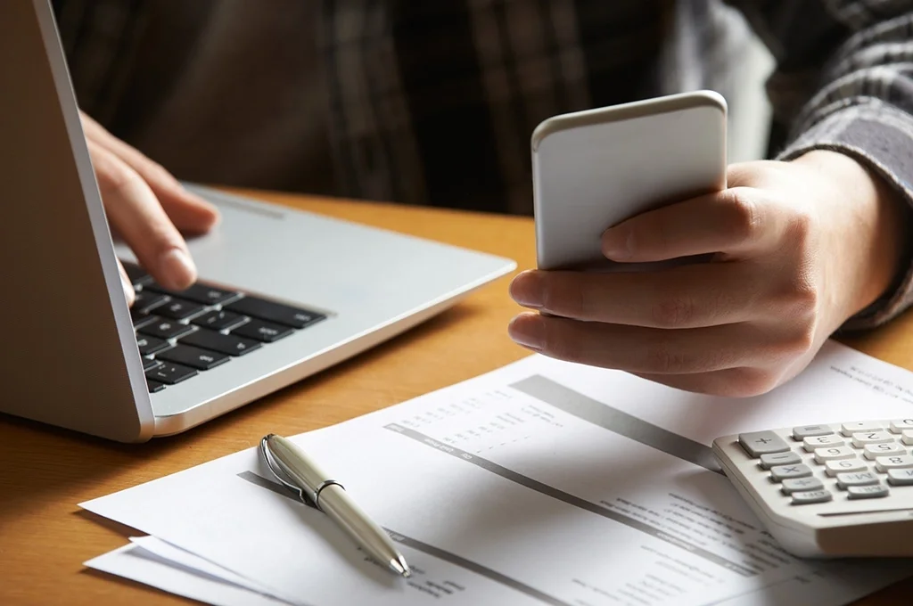 A veteran at home assessing his finances while considering debt consolidation