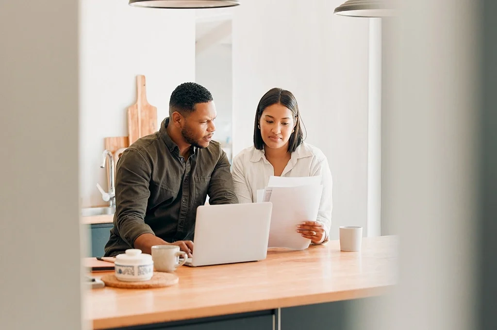 A veteran sits with his wife as they look for tax tips for veterans