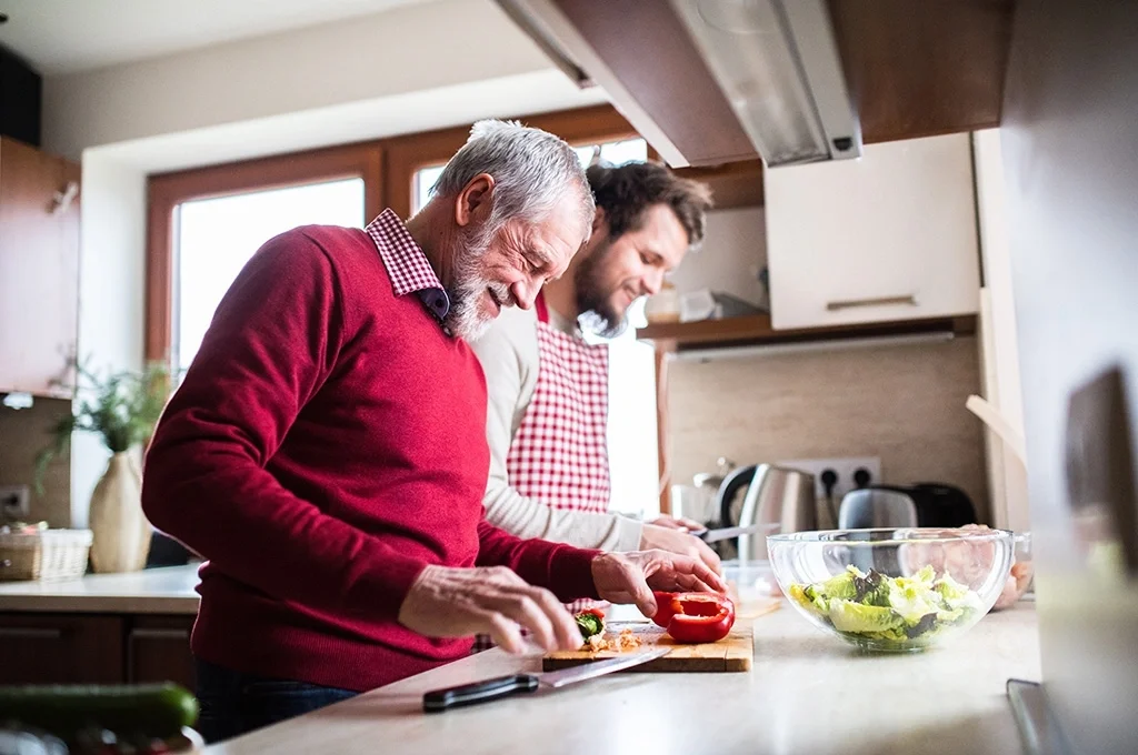 A veteran prepares dinner at home with his father