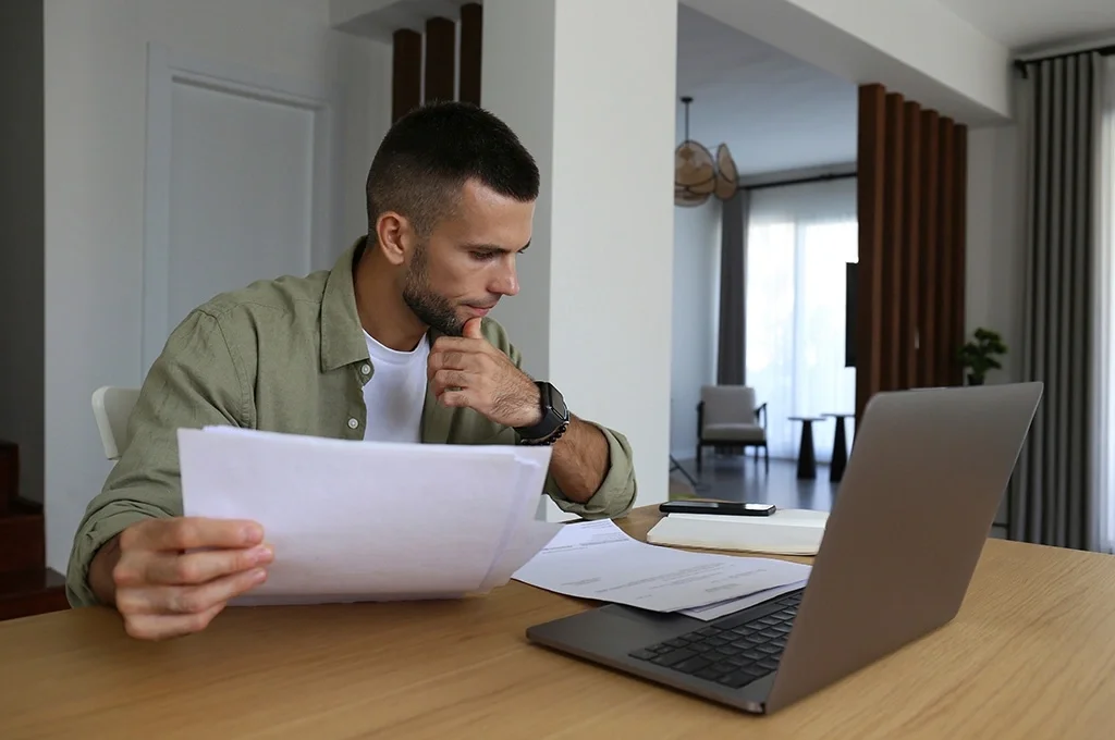 A man examines his finances before deciding to roll over his TSP to an IRA