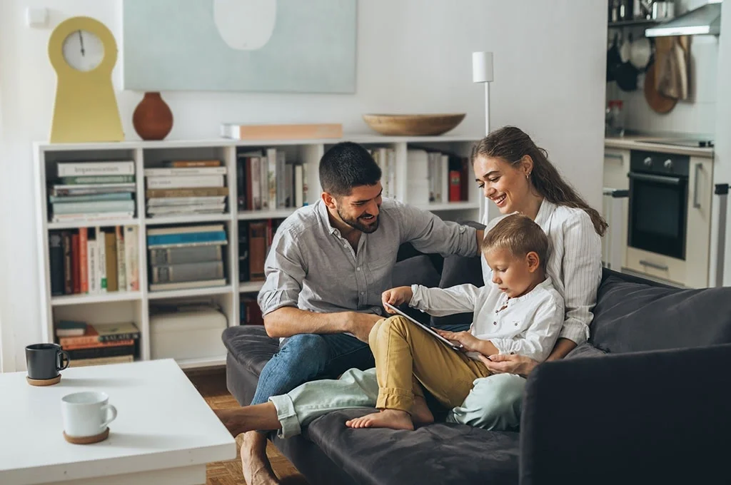 A veteran family using a tablet together in the living room