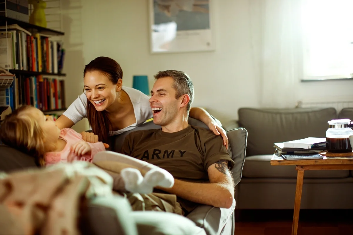 A veteran sits at home with his family