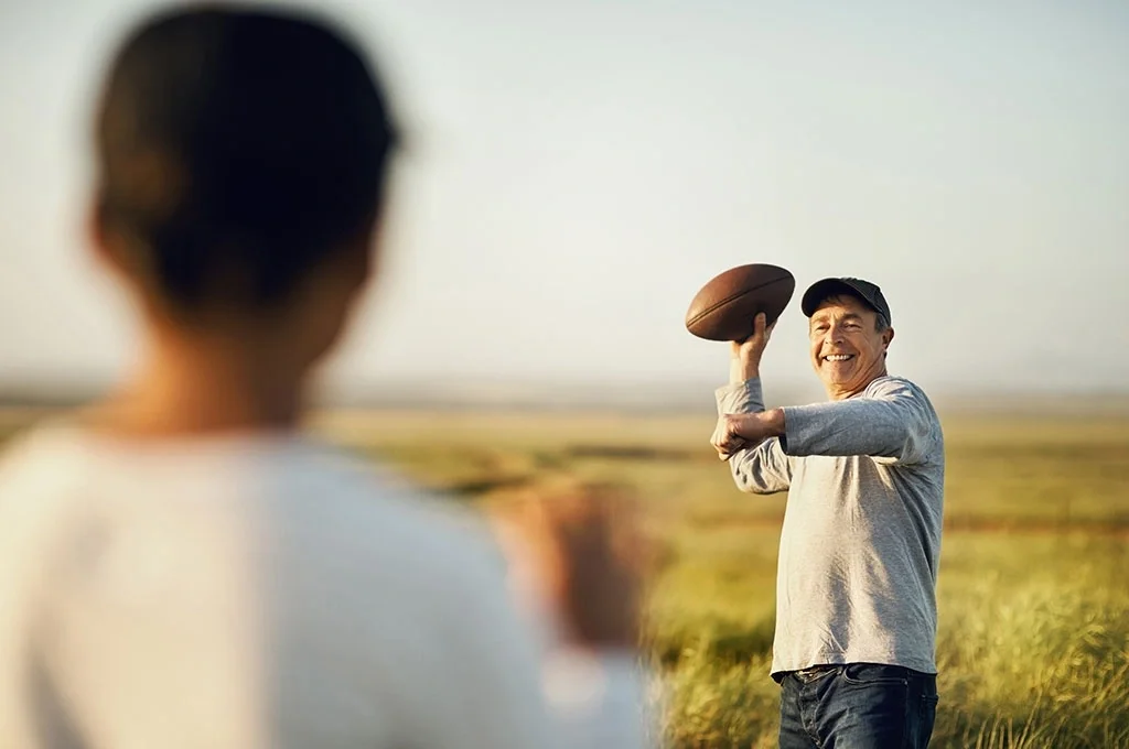 A father and son throw a football in Texas