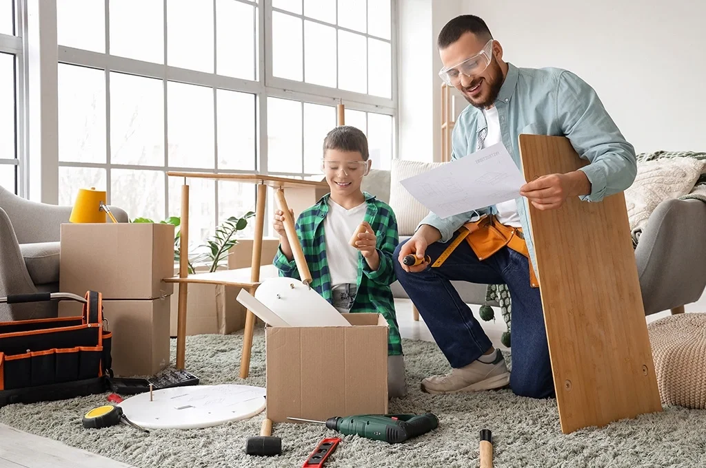 A man and son assemble a shelf together at home