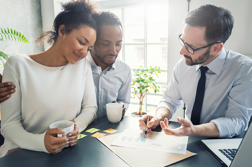 A veteran couple exploring wealth planing with their financial advisor