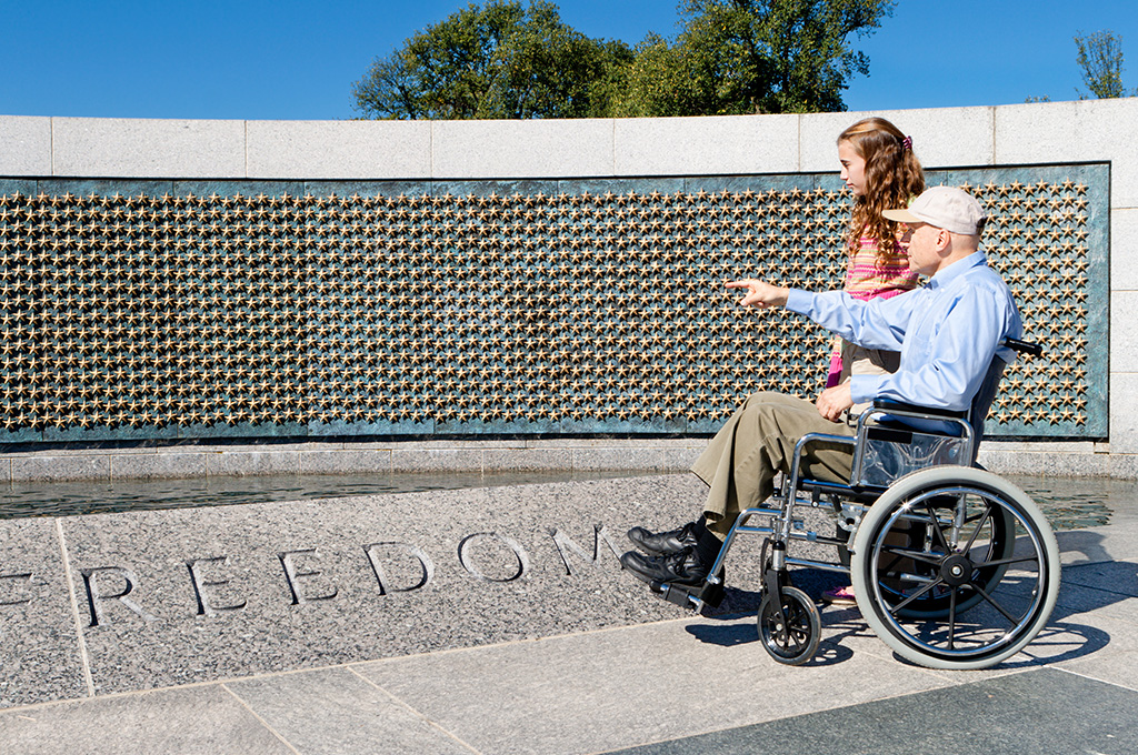 A veteran on veteran SSDI showing a family member a military memorial