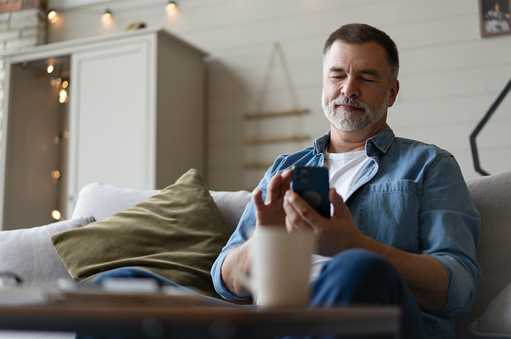 A veteran at home looking at his emails for replies to job applications after finding out about transferable skills military to civilian