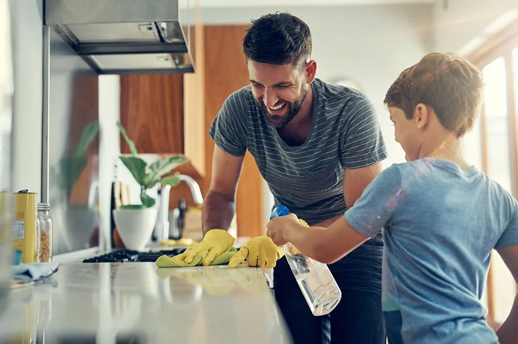 A father and son clean the kitchen together