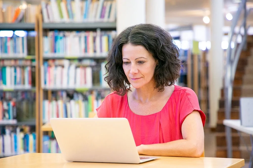 A veteran spouse studies at a college library