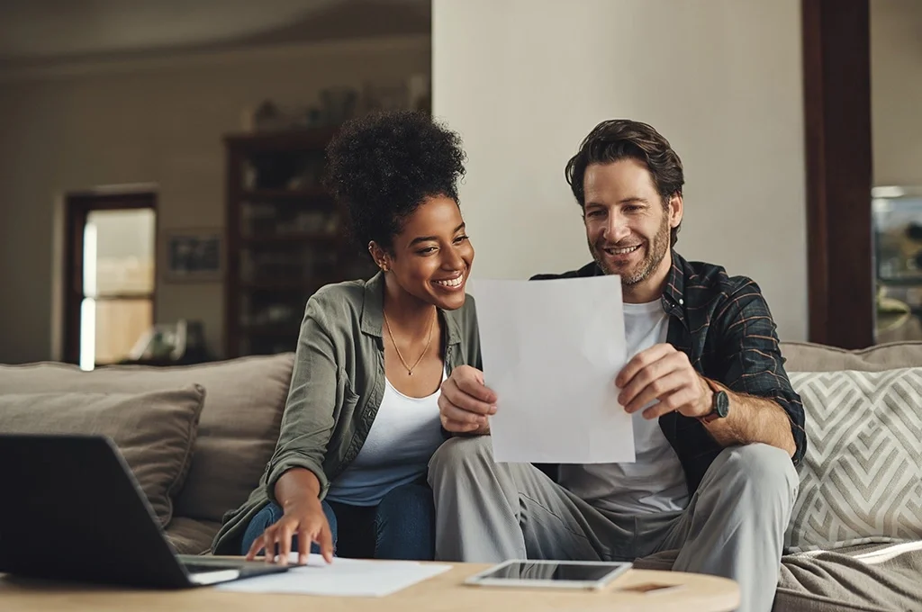 A veteran and her spouse examine paperwork regarding veterans' benefits banking programs