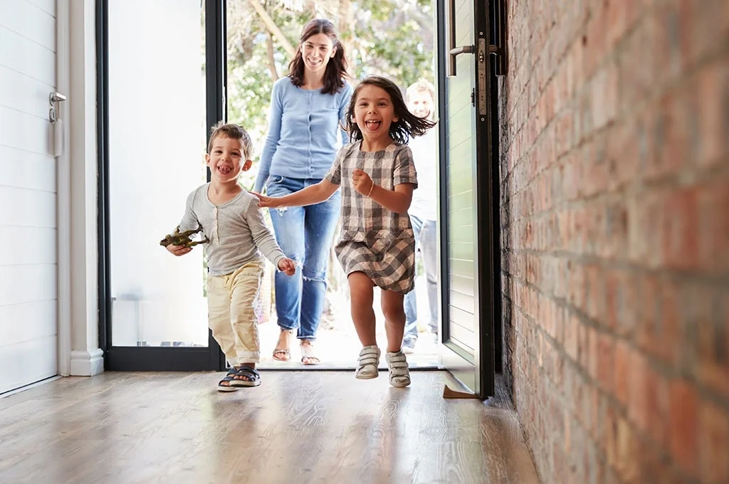 Veteran entering her home with her two children