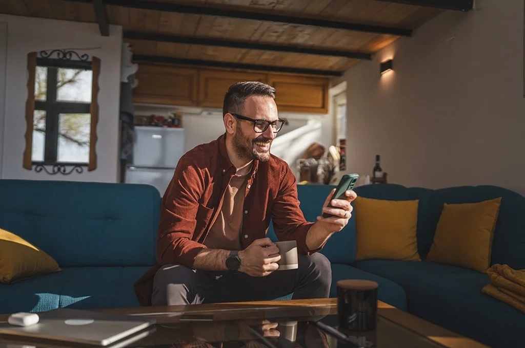 A man takes advantage of the best interest rates for veterans, applying for a bank account using his phone